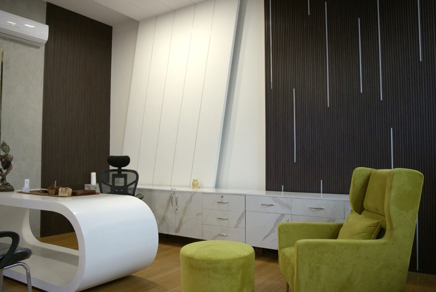 Director cabin curved white desk dark panel wall backlit gold edge — corporate office Jaipur — Endless Interiors and Construction